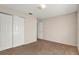 Cozy bedroom with neutral walls, carpeted floors, and a spacious closet for storage at 8551 N Hyaleah Rd, Tampa, FL 33617