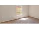 Bright and airy bedroom with a large window, neutral carpet, and plenty of natural light at 8551 N Hyaleah Rd, Tampa, FL 33617