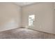 This spacious carpeted bedroom offers a bright window for natural light at 8551 N Hyaleah Rd, Tampa, FL 33617