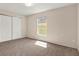 This bedroom features a bright window and closet with folding doors at 8551 N Hyaleah Rd, Tampa, FL 33617