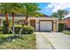 Charming single-story home with well-manicured landscaping and attached garage at 8551 N Hyaleah Rd, Tampa, FL 33617