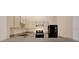 Well-lit kitchen with white cabinets, modern appliances, and a functional layout for easy cooking at 8551 N Hyaleah Rd, Tampa, FL 33617