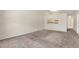 Spacious living area with plush carpet, a pass-through to the kitchen, and a seamless, airy design at 8551 N Hyaleah Rd, Tampa, FL 33617