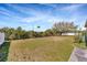 Large backyard with grassy area and mature trees; partially fenced in at 8714 Sandy Plains Dr, Riverview, FL 33578