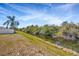 Backyard with grassy area and retention pond views; partially fenced in at 8714 Sandy Plains Dr, Riverview, FL 33578