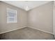Bedroom features carpeted floor, neutral walls, one window, and an elegant chandelier at 8714 Sandy Plains Dr, Riverview, FL 33578
