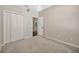 Bright bedroom with neutral walls, carpet flooring, closet, and bathroom access at 8714 Sandy Plains Dr, Riverview, FL 33578