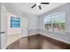 Cozy bedroom with hardwood floors, chair rail, and large window allowing ample natural light at 8714 Sandy Plains Dr, Riverview, FL 33578