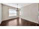 Dining area featuring hardwood floors, neutral paint, and a chandelier at 8714 Sandy Plains Dr, Riverview, FL 33578