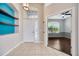 Inviting foyer with neutral walls, tile flooring, bright lighting, and an adjacent living space at 8714 Sandy Plains Dr, Riverview, FL 33578