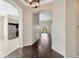 Open hallway with hardwood floors, archways, views into the kitchen, and backyard access at 8714 Sandy Plains Dr, Riverview, FL 33578
