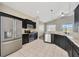 Modern kitchen featuring stainless steel appliances, dark cabinets, and granite countertops at 8714 Sandy Plains Dr, Riverview, FL 33578