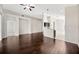 Open-concept living space with hardwood floors, neutral paint, and ample natural light at 8714 Sandy Plains Dr, Riverview, FL 33578