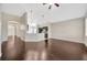 Spacious living room with hardwood floors open to the kitchen and entryway at 8714 Sandy Plains Dr, Riverview, FL 33578