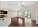 Open-concept living area with vaulted ceilings, hardwood floors, and sliding glass doors to the lanai at 8714 Sandy Plains Dr, Riverview, FL 33578