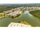 Aerial view of the community with tennis courts, a pool, parking, lake, trees, and buildings at 10039 62Nd N Ave # 14, St Petersburg, FL 33708