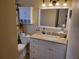 Well-lit bathroom featuring a granite vanity and shower with modern fixtures and ample storage at 10039 62Nd N Ave # 14, St Petersburg, FL 33708