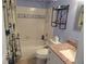 Well-lit bathroom with nautical themed shower curtain at 10039 62Nd N Ave # 14, St Petersburg, FL 33708