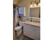 Well-lit bathroom featuring a granite vanity and shower with modern fixtures and ample storage at 10039 62Nd N Ave # 14, St Petersburg, FL 33708