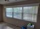 Bright bedroom featuring large windows with vertical blinds, offering plenty of natural light at 10039 62Nd N Ave # 14, St Petersburg, FL 33708