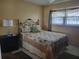 Comfortable bedroom features a patterned quilt and plenty of natural light at 10039 62Nd N Ave # 14, St Petersburg, FL 33708