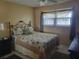 Comfortable bedroom features a patterned quilt and plenty of natural light at 10039 62Nd N Ave # 14, St Petersburg, FL 33708