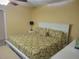 Spacious bedroom with a king-size bed, ceiling fan, and natural light creates a relaxing retreat at 10039 62Nd N Ave # 14, St Petersburg, FL 33708