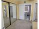 Bright bedroom featuring mirrored closet doors, tile floors, and multiple doorways at 10039 62Nd N Ave # 14, St Petersburg, FL 33708