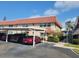 Exterior of building with a car parked under the covered parking with a walkway on a sunny day at 10039 62Nd N Ave # 14, St Petersburg, FL 33708