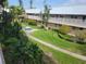 Community courtyard view with manicured green spaces and mature palm trees at 10039 62Nd N Ave # 14, St Petersburg, FL 33708