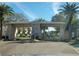 Entrance to Long Bayou at The Villas with palm trees and other landscaping at 10039 62Nd N Ave # 14, St Petersburg, FL 33708