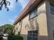 Exterior view of building with stucco walls, a red tile roof and mature trees at 10039 62Nd N Ave # 14, St Petersburg, FL 33708
