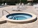 Community hot tub with patio, lounge chairs, and a view of the pool and lake at 10039 62Nd N Ave # 14, St Petersburg, FL 33708