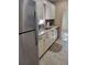 Galley kitchen featuring white cabinets, granite countertops, and stainless steel appliances at 10039 62Nd N Ave # 14, St Petersburg, FL 33708
