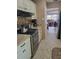 Modern kitchen with stainless steel appliances and a view into the adjacent living room at 10039 62Nd N Ave # 14, St Petersburg, FL 33708