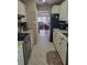 Modern kitchen with stainless steel appliances and a view into the adjacent living room at 10039 62Nd N Ave # 14, St Petersburg, FL 33708