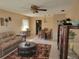Open concept: living room flows into dining area with tile floors, ceiling fan, and large windows at 10039 62Nd N Ave # 14, St Petersburg, FL 33708