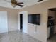 Open-concept living area with mounted TV, and a view of the kitchen and hallway at 10039 62Nd N Ave # 14, St Petersburg, FL 33708