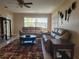 Comfortable living room with neutral walls, ceiling fan, and modern furnishings at 10039 62Nd N Ave # 14, St Petersburg, FL 33708