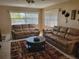 Spacious living room with tile flooring and leather couches at 10039 62Nd N Ave # 14, St Petersburg, FL 33708
