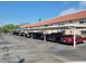 Exterior view of covered parking area with several cars parked underneath on a bright sunny day at the complex at 10039 62Nd N Ave # 14, St Petersburg, FL 33708