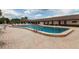 Community pool with brick patio and chaise lounge chairs on a bright and sunny day at 10039 62Nd N Ave # 14, St Petersburg, FL 33708