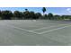 Outdoor tennis court surrounded by a lush green landscape for recreational activity at 10039 62Nd N Ave # 14, St Petersburg, FL 33708