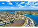 Stunning aerial view of waterfront community with lake, pool, and lush landscaping on a sunny day at 113 Seahorse Se Dr # D, St Petersburg, FL 33705