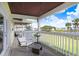 Balcony with chairs overlooking a tranquil pond and landscaped community at 113 Seahorse Se Dr # D, St Petersburg, FL 33705