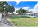 Large dog park featuring a grassy area, benches, and a covered parking area for residents' convenience at 113 Seahorse Se Dr # D, St Petersburg, FL 33705