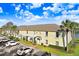 Bright yellow condo building with lush landscaping and ample parking at 113 Seahorse Se Dr # D, St Petersburg, FL 33705