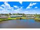 Waterfront condo community with lush lawn and palm trees, beside a large lake and pool at 113 Seahorse Se Dr # D, St Petersburg, FL 33705