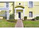 Inviting front entrance with a brick pathway, well-maintained landscaping, and a charming covered entryway at 113 Seahorse Se Dr # D, St Petersburg, FL 33705