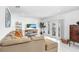 Bright living room with contemporary furniture, TV, and sliding doors to the outside at 113 Seahorse Se Dr # D, St Petersburg, FL 33705